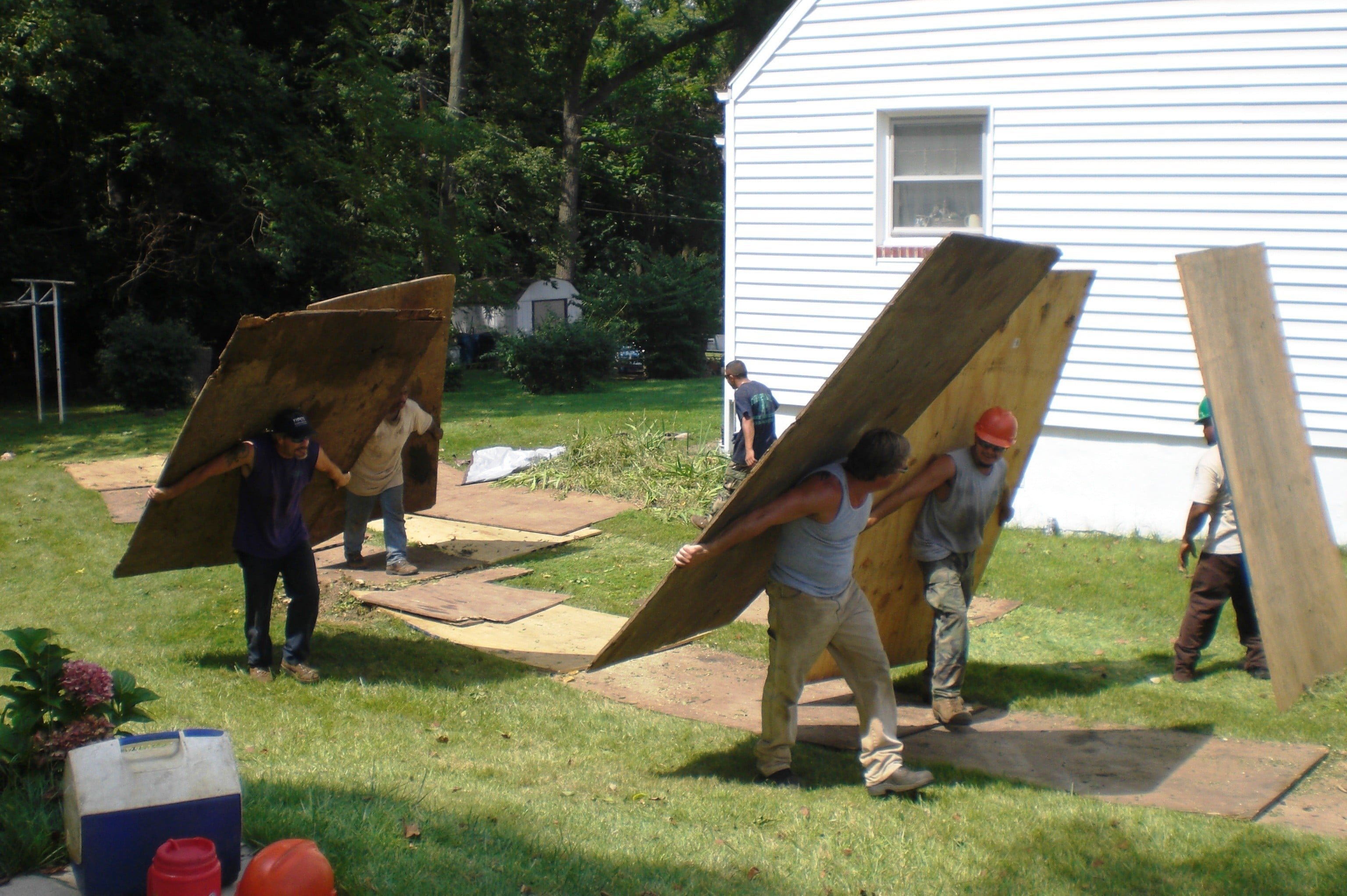 Men Carrying Plywood